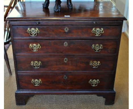 An 18th century mahogany chest of drawers having a full width slide over four long graduated cockbeaded drawers, raised on sh