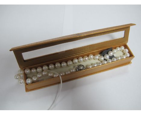 A Modern Large Fresh Water Pearl Bead Necklace, the uniform beads to circular clasp, collet set to the centre.