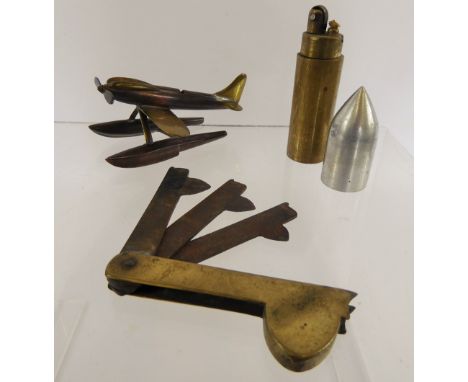 A Trench Art Model of a plane 'Seafire' (wf), together with a cigarette lighter in the form of a bullet casing and a blood le
