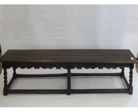 An Antique Oak Coffin Bench, raised on six barley twist legs with stretchers, approx 153 x 47 x 32 cms.