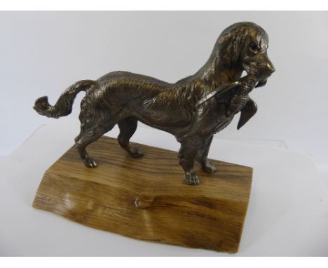 A Model depicting a 'Golden Retriever & Pheasant', on a naturalistic base, approx 24 cms from nose to tail.