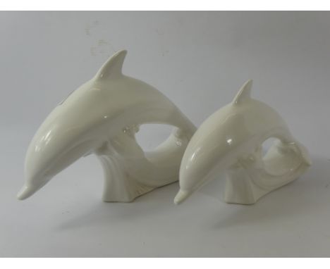 Two White Poole Pottery Dolphins, one approx 18 x 26 and one smaller, approx 15 x 22 cms.