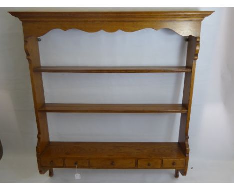 A Light Oak Plate Rack, having two shelves with four small and one large spice drawer beneath, approx 109 x 119 x 19 cms