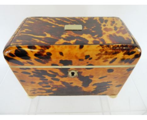 An Antique Blonde Tortoiseshell Tea Caddy, the interior fitted with two lidded compartments with ivory finials, approx 17 x 9