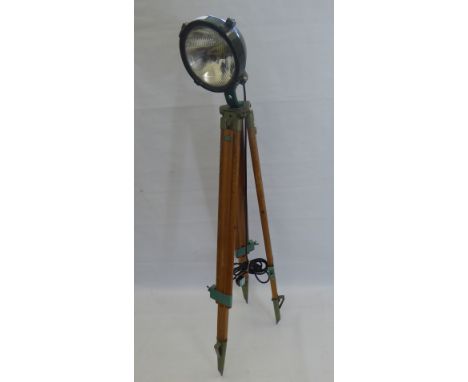 A Vintage Film Studio Chrome and Plastic Lamp, on wooden tri-pod base.