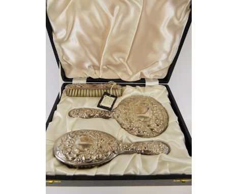 A Sterling Silver Brush Set, comprising mirror, hairbrush and clothes brush, Birmingham hallmark, mm B & Co, in the original 