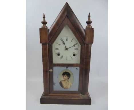 A Gothic Style Ansonia Clock Co Mantel Clock, white enamel face, Roman dial, the glaze door front depicting a young man, appr