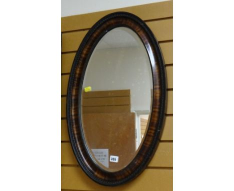 A good vintage oval mahogany framed bevel wall mirror