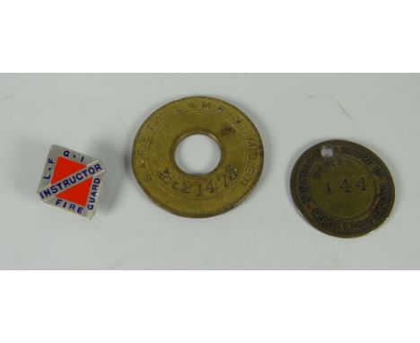 A Glamorgan Coal Company Ltd Llwynypia pit safety lamp token together with another &amp; a fire guard label badge