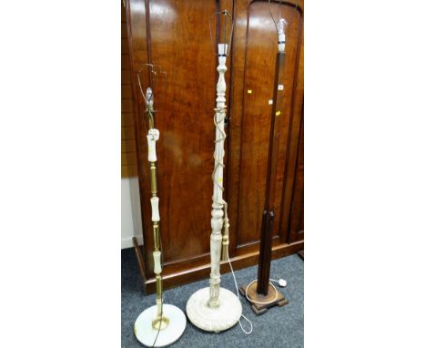 A vintage wooden standard lamp, a painted carved standard lamp & another