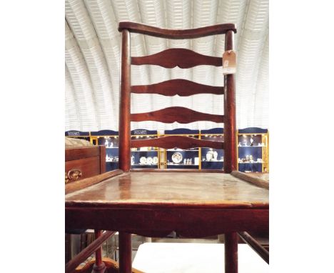 A 19thC Elm ladder backed side chair with solid seat