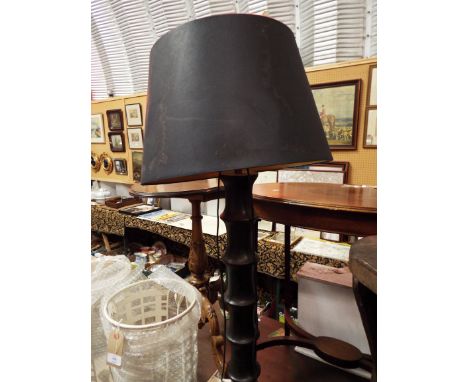 An ebonised turned standard lamp