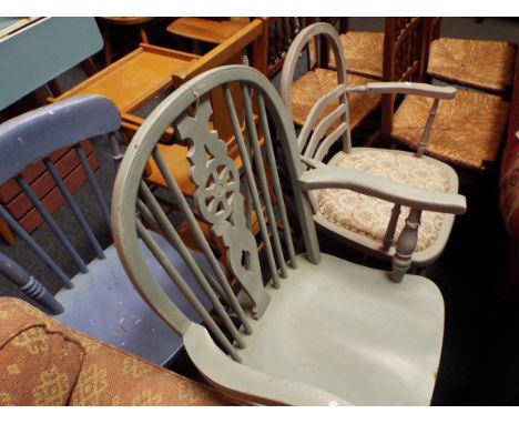 Three painted kitchen chairs to include a wheel and stick back carver chair