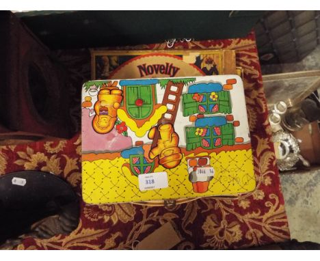 A child's tin plate carry case with assorted playing cards, spider web game and novelty Miraculum
