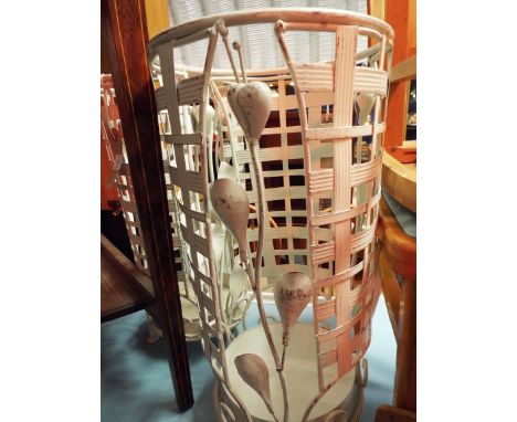 A pair of ornate cream painted floral decorated stick stands