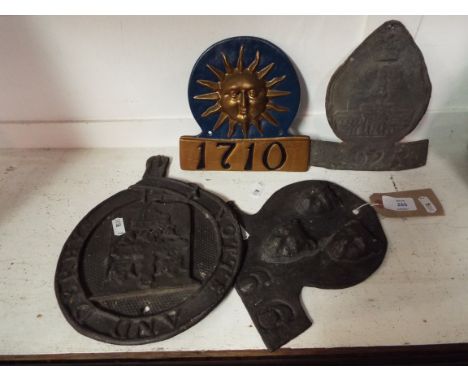 Three lead and one cast iron vintage fire insurance marks to include three leopards heads 5266,  Notts and Derby and two othe