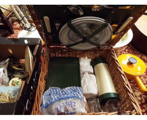 A vintage wicker picnic hamper with contents