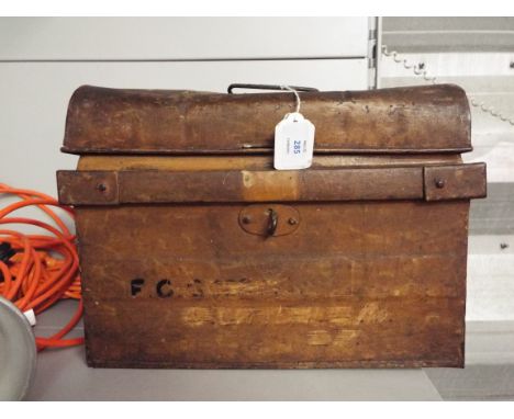 A vintage miniature tin trunk