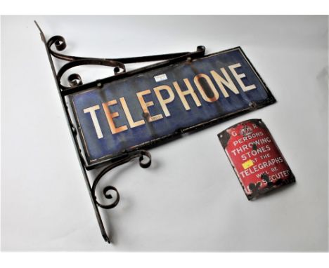 Two vintage metal signs, one wall mounted "Telephone", the other "Persons Throwing Stones at The Telegraphs Will Be Prosecute