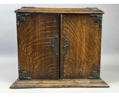 EARLY 20TH CENTURY OAK SMOKER'S CABINET,housing a pipe rack and mixing jar, along with a Doulton Slater's Patent bottle vase 