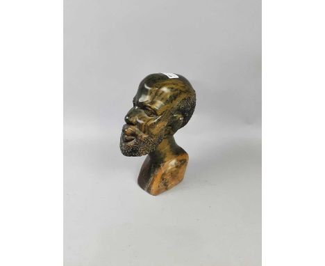 AFRICAN CARVED SOAPSTONE BUST OF A MAN,24cm high, along with an African figural ashtray, a small composite figure of a Buddha