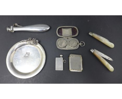 Silver cigar cutter hallmarked Birmingham, Silver coin disk stamped 830,a white metal sovereign holder, a white metal vesta c