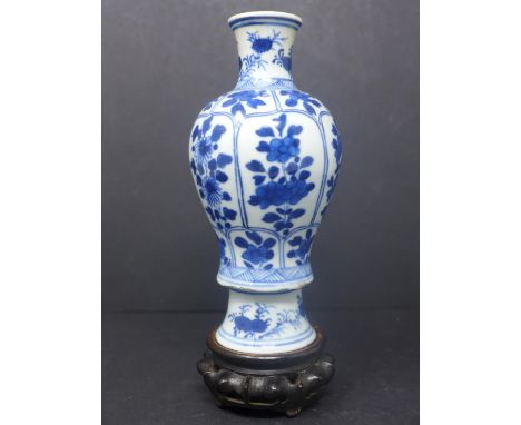 A Chinese baluster vase, blue and white porcelain,  floral design probably K?ang Hsi period with hardwood stand, H. 15 cm 