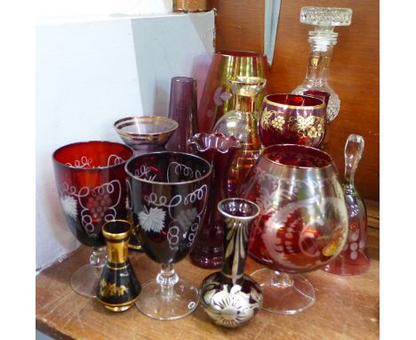 A collection of ruby glass including an etched glass brandy and two wines and other glass