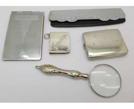 A 925 silver stamp holder, a plated matchbook holder, a magnifying glass, a notebook, etc.