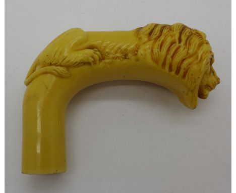 A walking stick handle depicting a lion