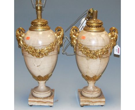 A pair of contemporary veined marble and gilt bronze mounted table lamps, in the Louis XVI style, each of ovoid form, having 