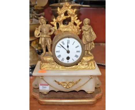 A late 19th century French gilt metal and alabaster mantel clock, the drum shaped clock with enamelled dial and Roman numeral