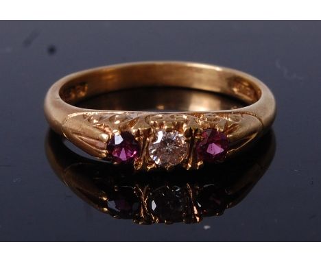 An Edwardian style 18ct gold, ruby and diamond dress ring, the centre brilliant cut diamond weighing approx 0.13ct, in a chas