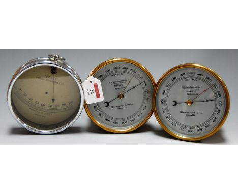 A pair of brass cased aneroid barometers, MkII, each having a silvered dial with millibar scale, signed T A Reynolds & Sons, 