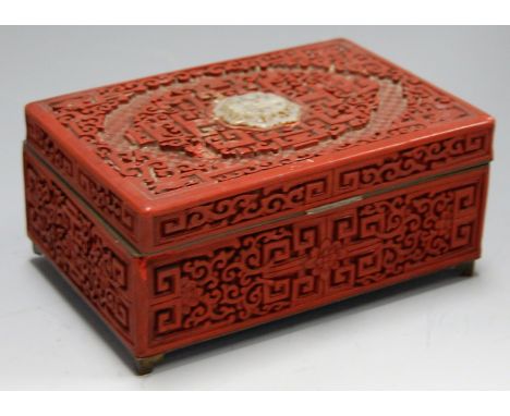 An early 20th century cinnabar lacquered and enamelled table cigarette box, of rectangular form, the hinged lid inset with pi