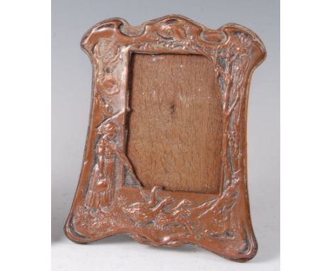 An Art Nouveau embossed silver plated easel photograph frame, of shaped outline, decorated with female standing figure herdin