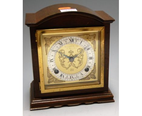 A mid-20th century walnut cased mantel clock, having brass dial with silvered chapter ring and Roman numerals, flanked by bra