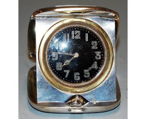 A mid 20th century silver cased travel alarm clock having black enamel dial with luminous Arabic numerals, maker EJ Clewley &