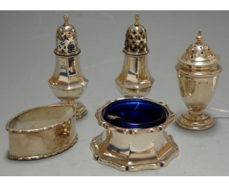 A pair of early 20th century silver lighthouse pepperettes, together with a silver open salt with blue glass liner and associ