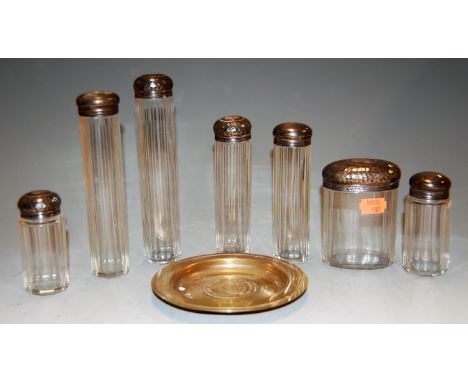 Assorted silver topped and faceted glass dressing table jars, to include hat-pin jars, tidies, and a silver plated commemorat