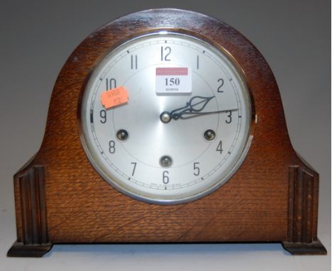 A 1950s Smiths oak cased mantel clock, having silvered dial with Arabic numerals, and eight day movement 