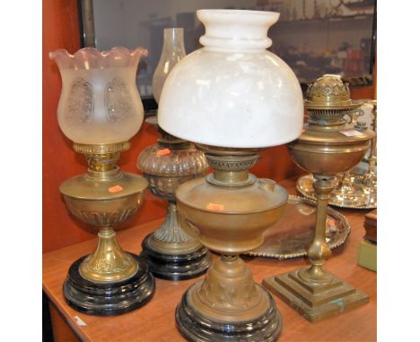 An early 20th century bass pedestal oil lamp, having opalescent glass shade; together with three other brass pedestal oil lam