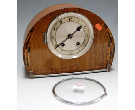 An Art Deco walnut cased mantel clock, having silvered dial with Arabic numerals and eight day movement, h.23cm
