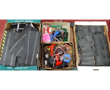 Three trays containing a quantity of Scalextric and slot-racing spares, accessories and track 
