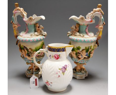 A modern Coalport Caughley mask-head jug; together with a pair of 20th century Continental pedestal ewers, each relief decora