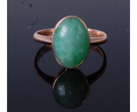 A 9ct gold and cabochon jade set dress ring, the jade measuring approx 12.5 x 9mm, 2.8g, size K