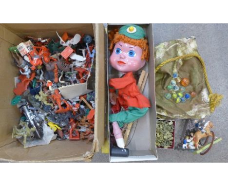 A Pelham puppet, glass marbles and a collection of plastic figures including cowboys and Indians, soldiers, etc.