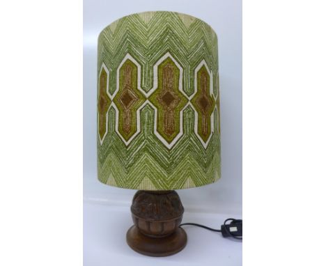 A carved oak table lamp base with retro lamp shade