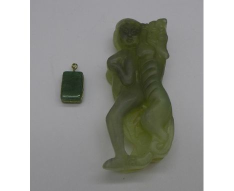 A jade pendant and a carving