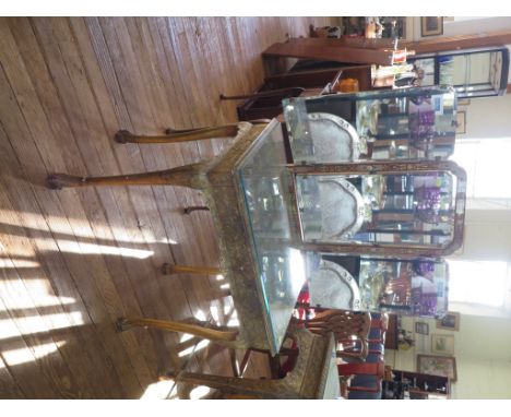 A George I style gilt wood dressing table, the triptych mirror over a foliate scroll decorated top above two similar frieze d